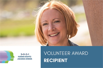 [ai] A smiling woman with shoulder-length hair is featured in a natural outdoor setting. The image includes a graphic at the bottom indicating 'Volunteer Award Recipient' and '2021 Human Rights Awards Dinner'.